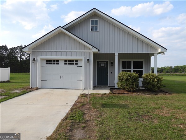 5915 Rye Patch Road Ludowici, GA 31316 - Photo 1 of 25 a front view of a house with a yard