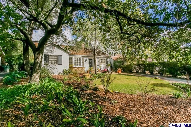 a view of a house with pool and sitting area