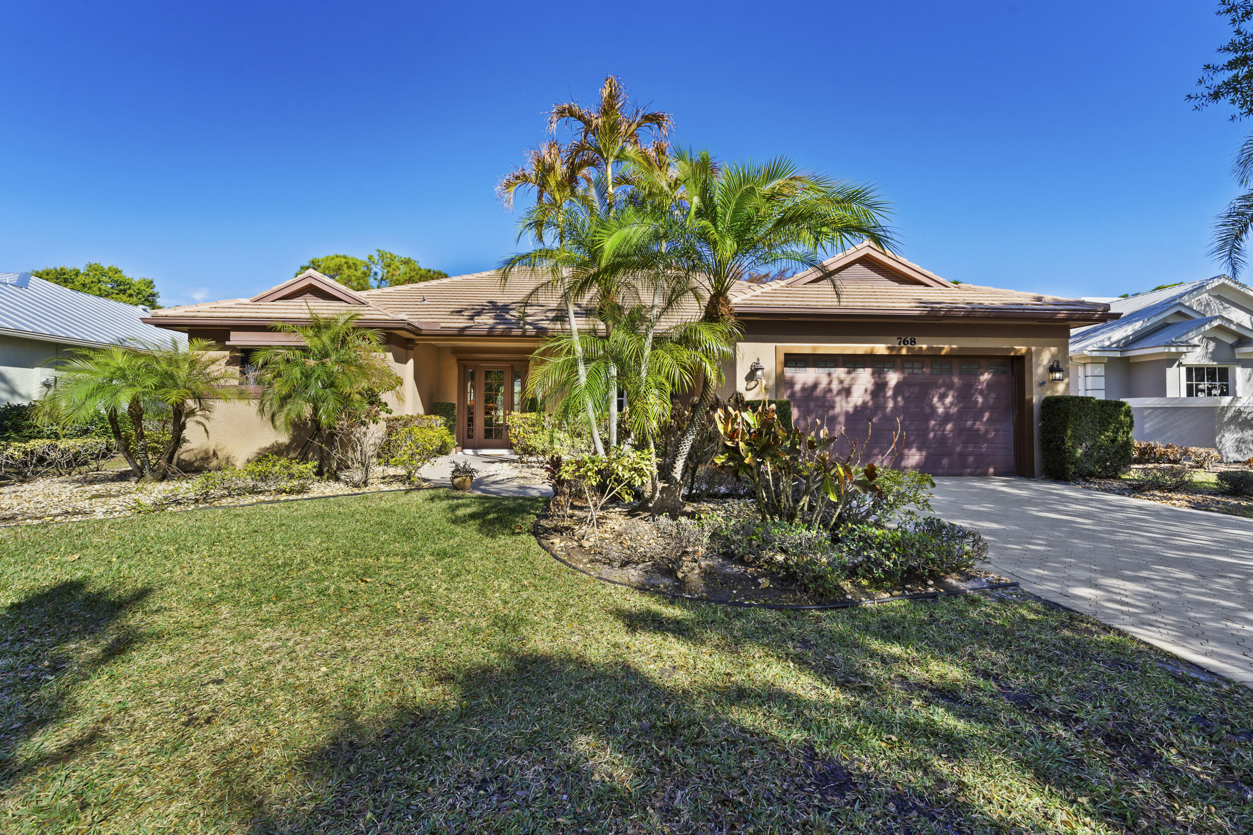 768 Southwest Whisper Ridge Trail Palm City, FL 34990 - Photo 1 of 40 a front view of a house with a yard