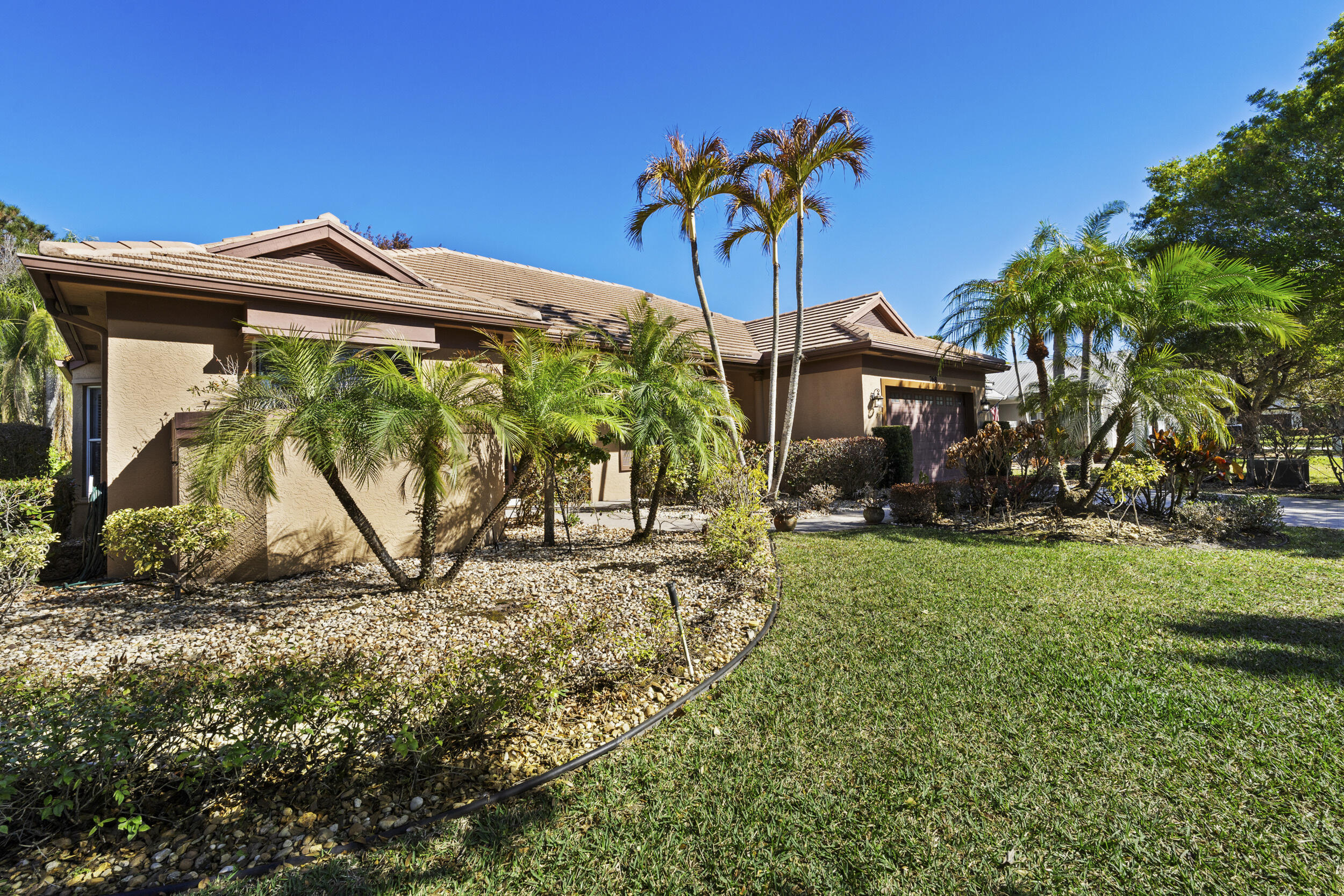 768 Southwest Whisper Ridge Trail Palm City, FL 34990 - Photo 2 of 40 a front view of a house with garden
