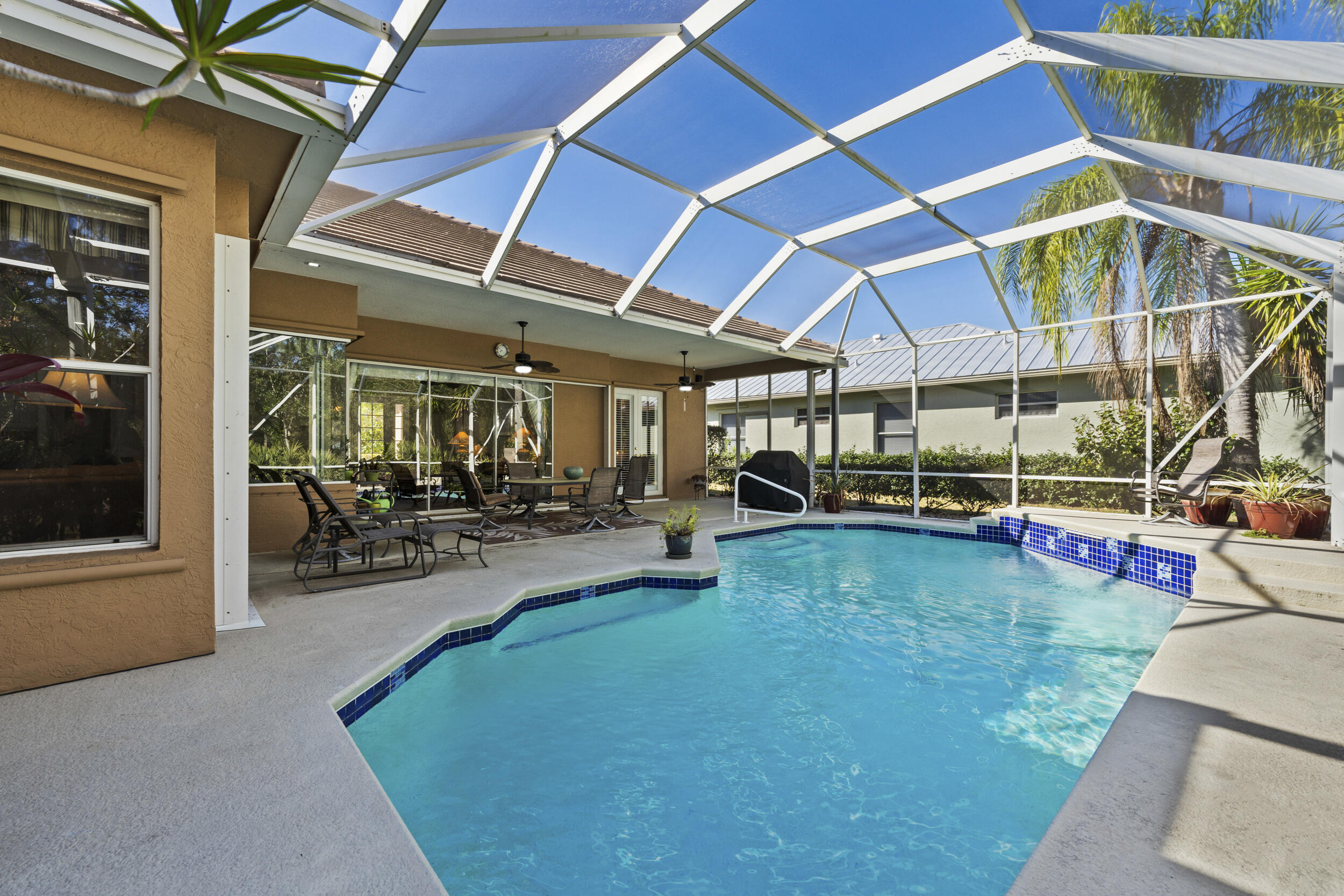 768 Southwest Whisper Ridge Trail Palm City, FL 34990 - Photo 27 of 40 a view of a backyard with swimming pool