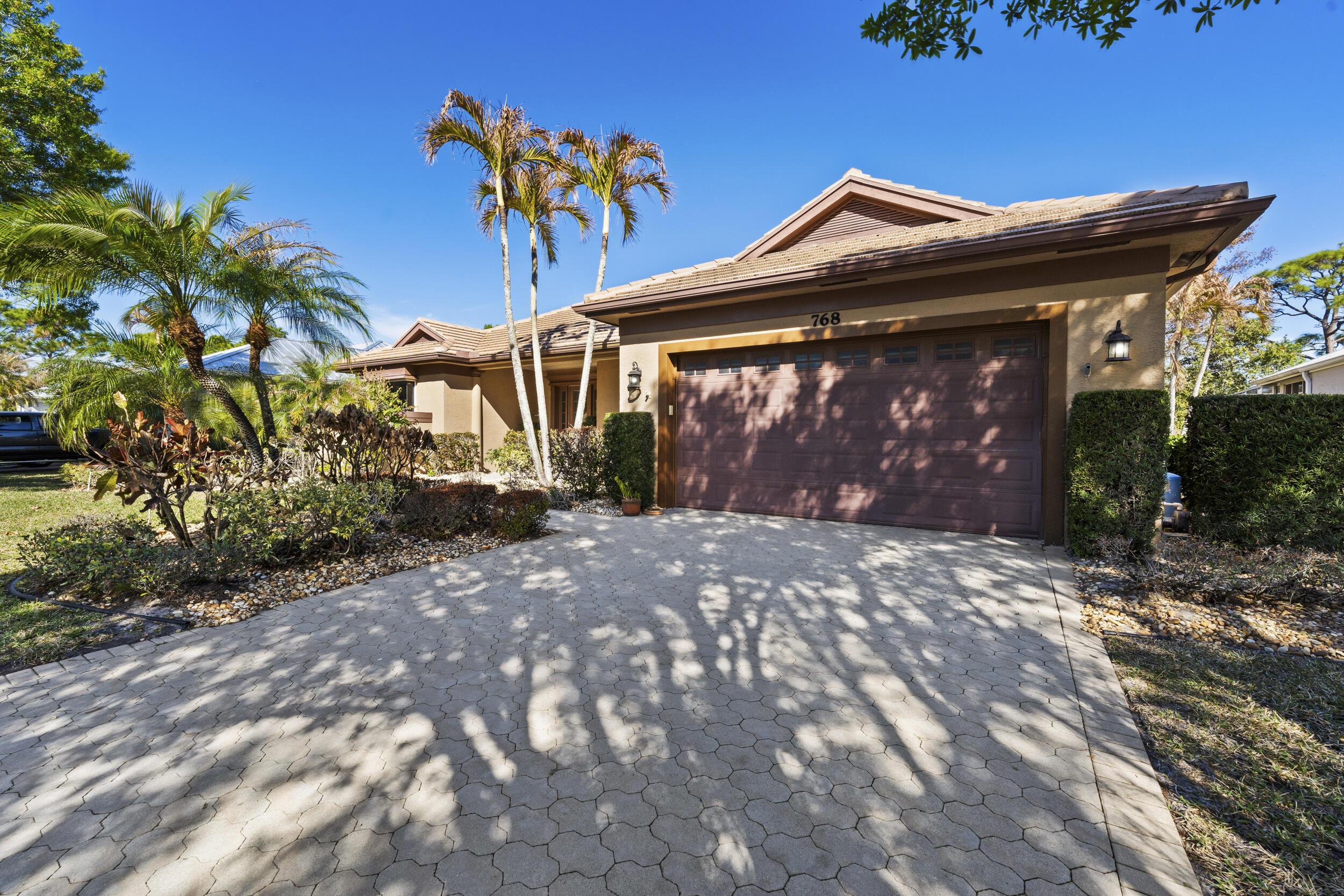 768 Southwest Whisper Ridge Trail Palm City, FL 34990 - Photo 3 of 40 a front view of a house