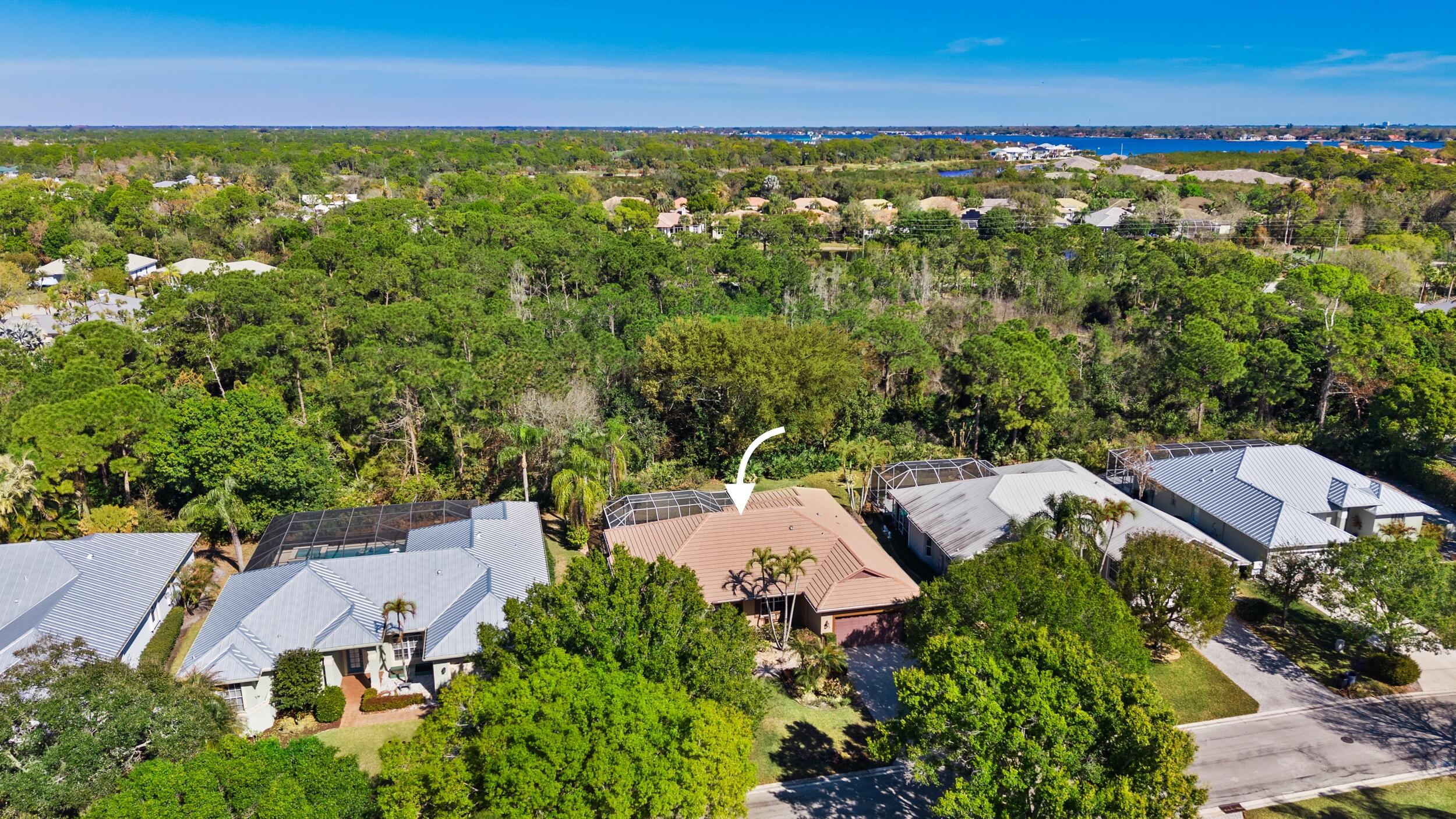 768 Southwest Whisper Ridge Trail Palm City, FL 34990 - Photo 31 of 40 an aerial view of residential houses with outdoor space and trees
