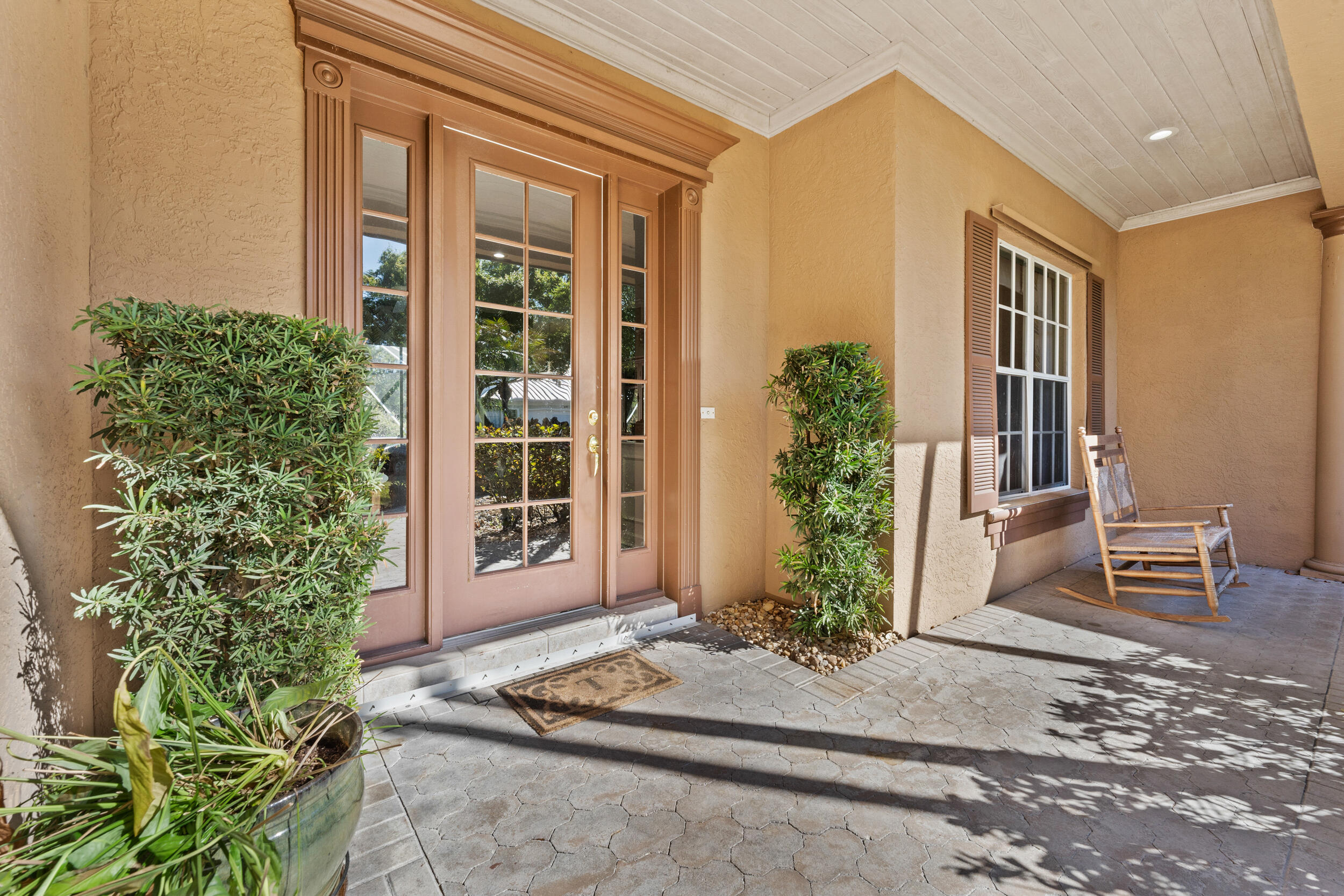 768 Southwest Whisper Ridge Trail Palm City, FL 34990 - Photo 4 of 40 a front view of a house with a yard