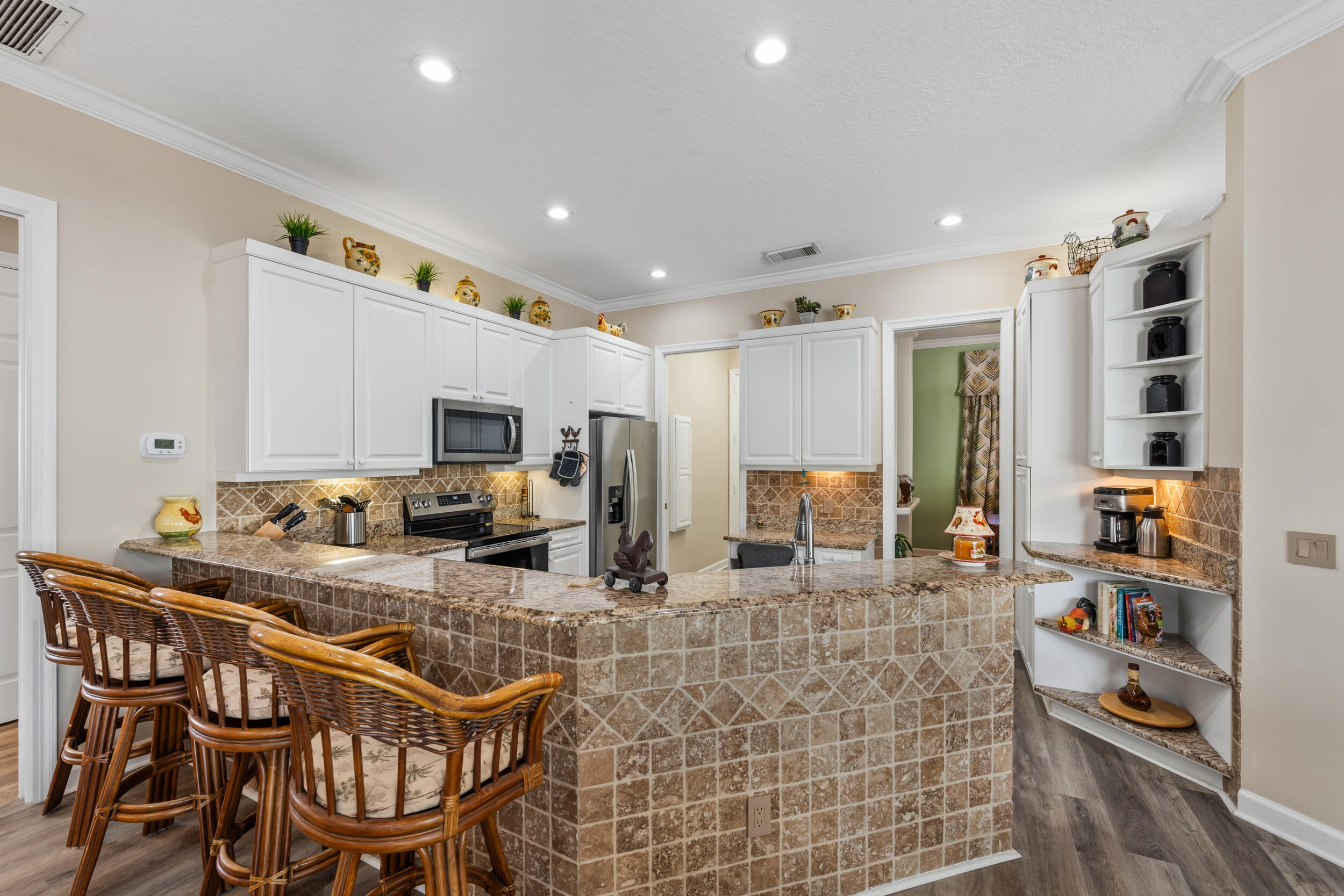 768 Southwest Whisper Ridge Trail Palm City, FL 34990 - Photo 10 of 40 a kitchen with stainless steel appliances kitchen island granite countertop a sink and cabinets