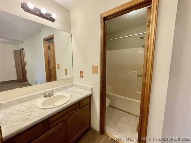 a bathroom with a granite countertop sink shower and a mirror
