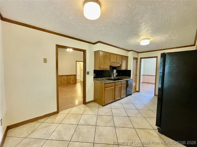 a kitchen with stainless steel appliances a refrigerator sink and cabinets