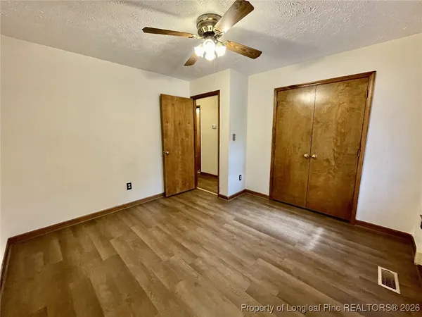 a view of an empty room with a ceiling fan