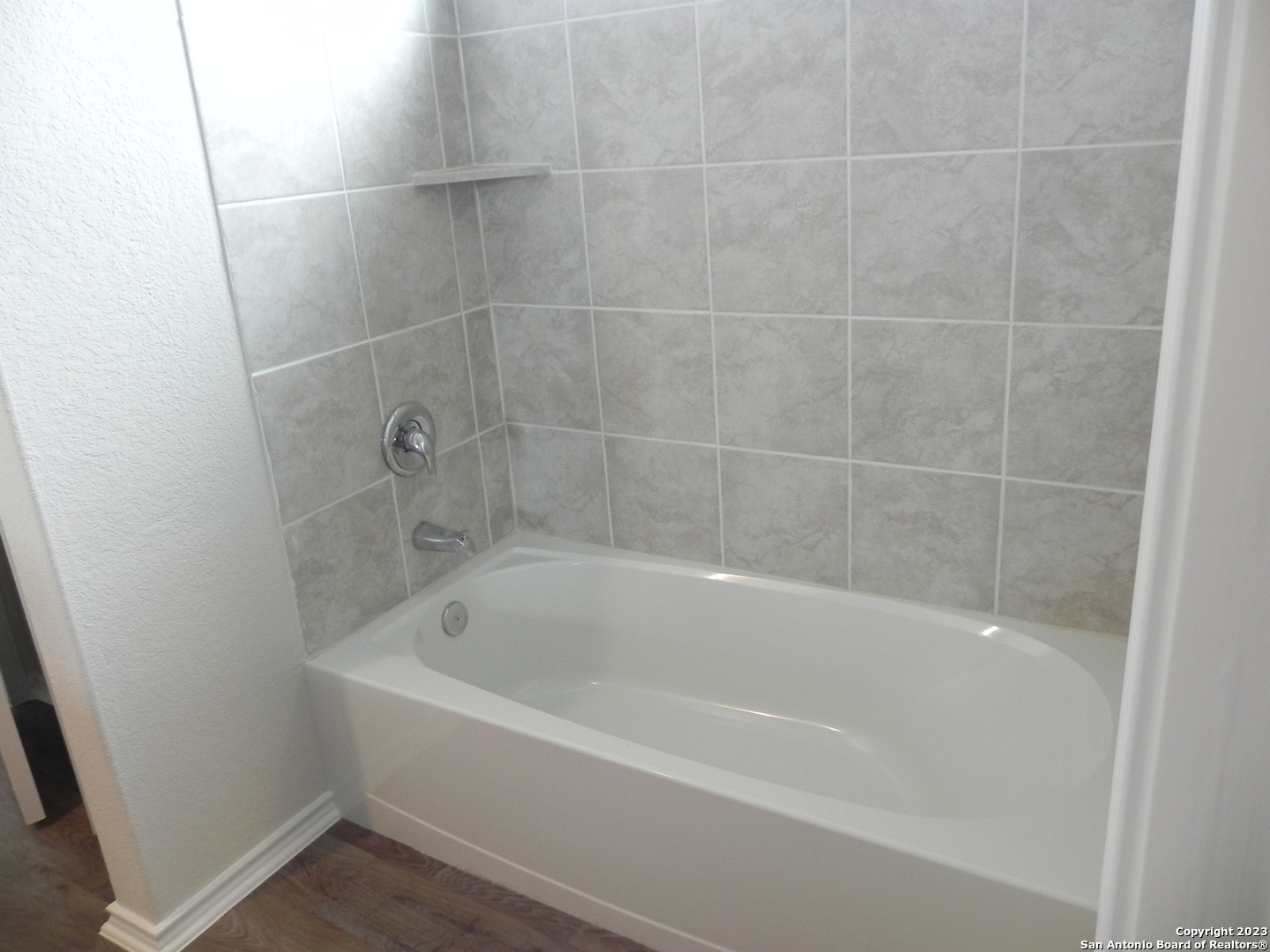 9506 Ranch Loop San Antonio, TX 78254 - Photo 14 of 25 a white bath tub sitting next to a small window