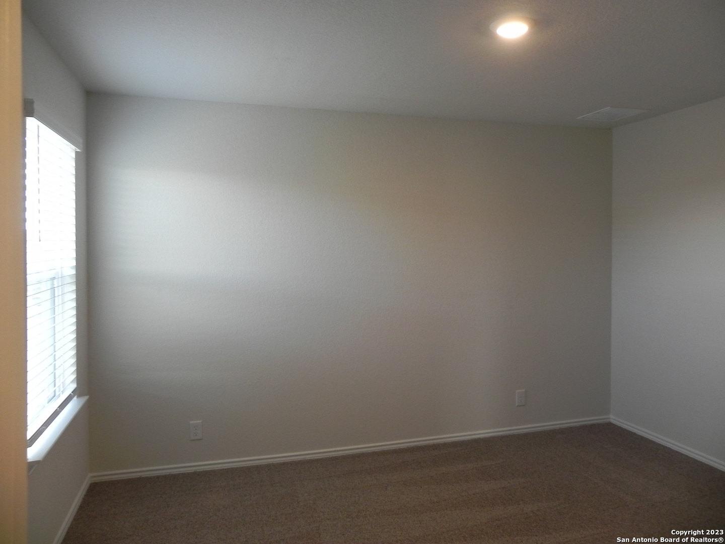9506 Ranch Loop San Antonio, TX 78254 - Photo 16 of 25 an empty room with a window