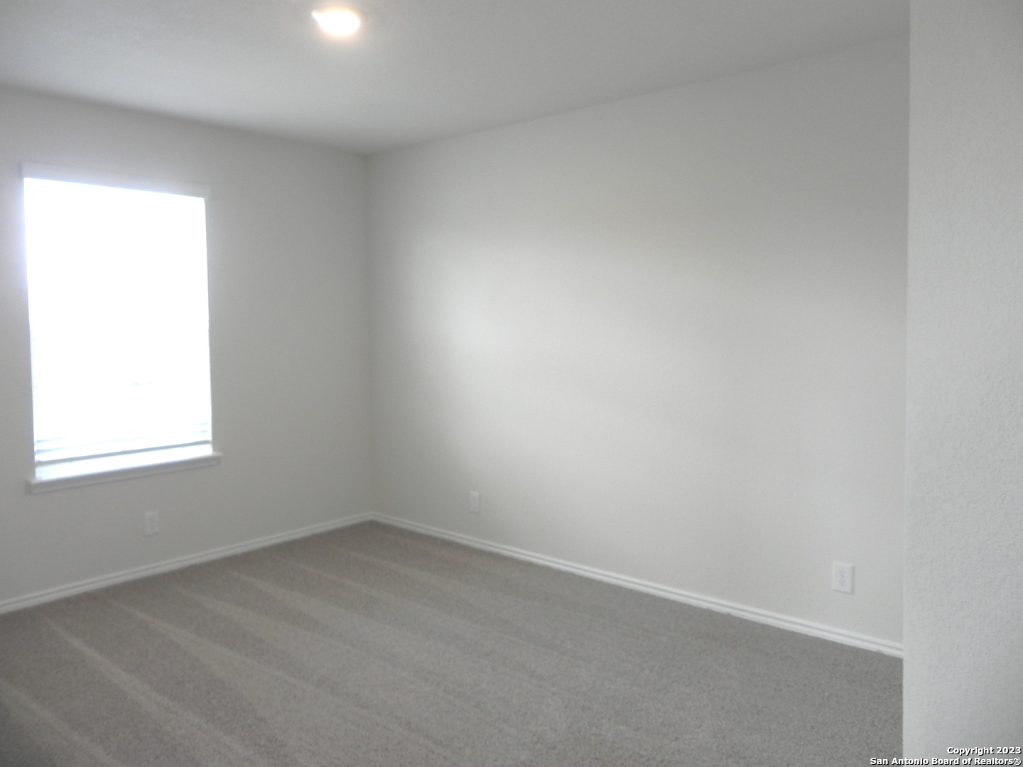 9506 Ranch Loop San Antonio, TX 78254 - Photo 18 of 25 an empty room with a window