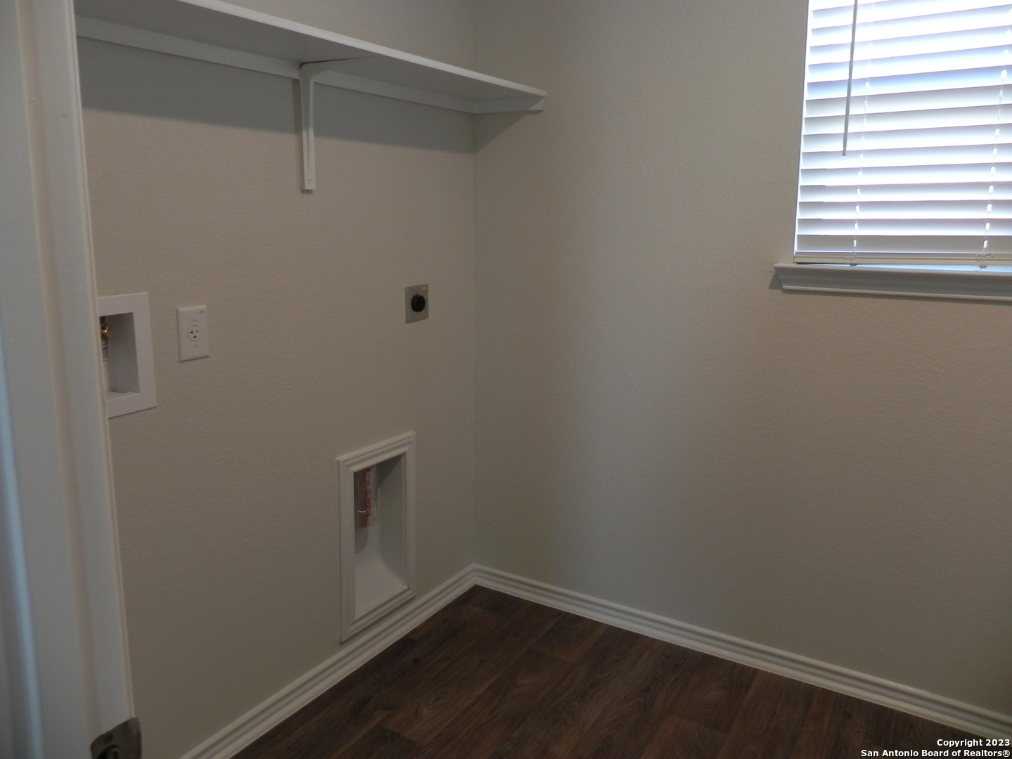 9506 Ranch Loop San Antonio, TX 78254 - Photo 10 of 25 a view of a small space with wooden floor and a window
