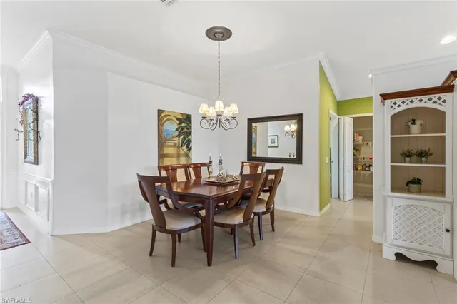 a view of a dining room with furniture and chandelier