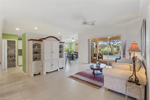 a living room with furniture a rug and white walls