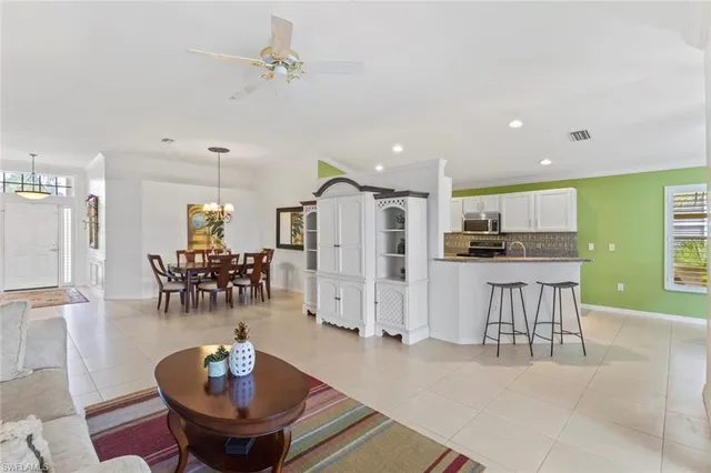 a living room with lots of furniture and kitchen view
