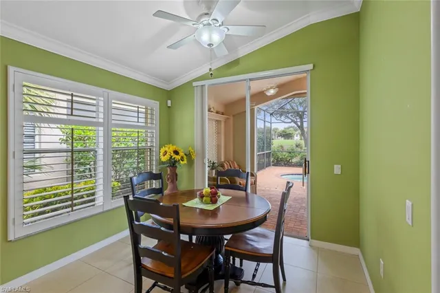 a dining room with furniture and a window