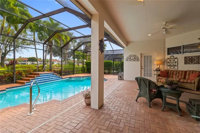 a view of a patio with a table and chairs and potted plants