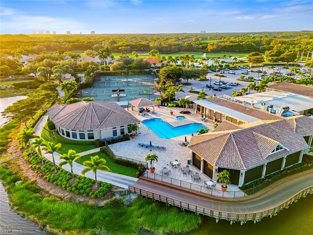 an aerial view of residential houses with outdoor space and ocean view