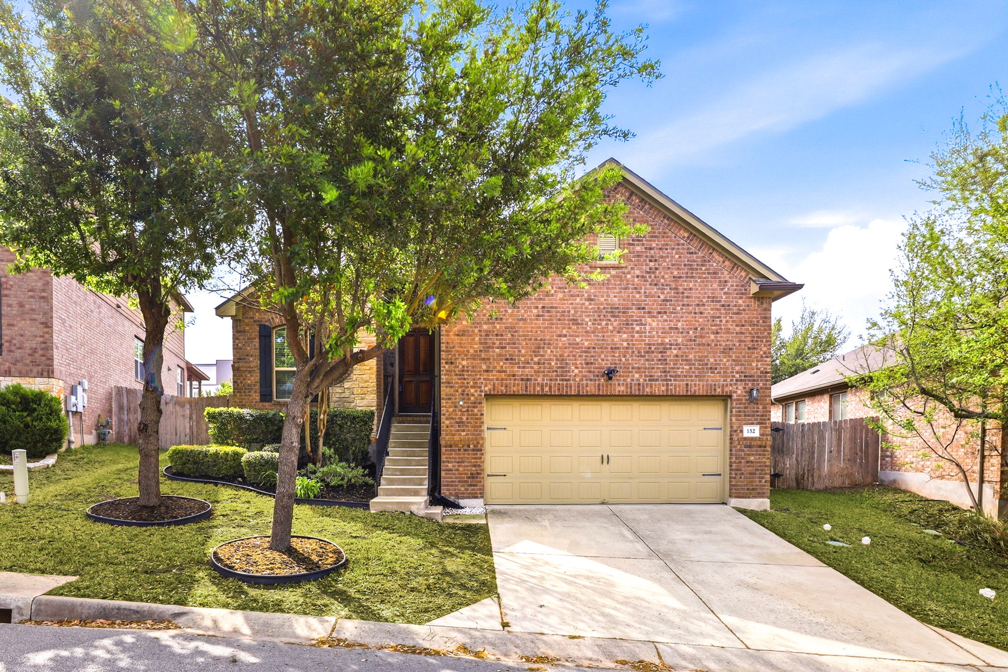152 Stone View Trail Austin, TX 78737 - Photo 1 of 29 a front view of a house with garden and trees