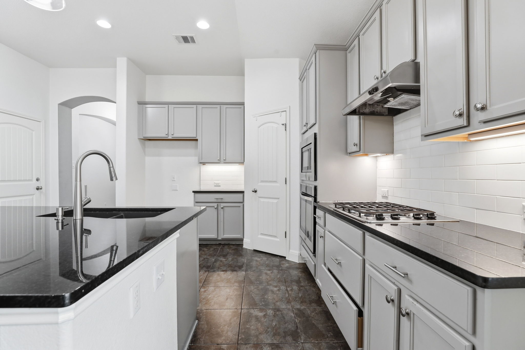 152 Stone View Trail Austin, TX 78737 - Photo 10 of 29 a kitchen with granite countertop a sink stove and cabinets