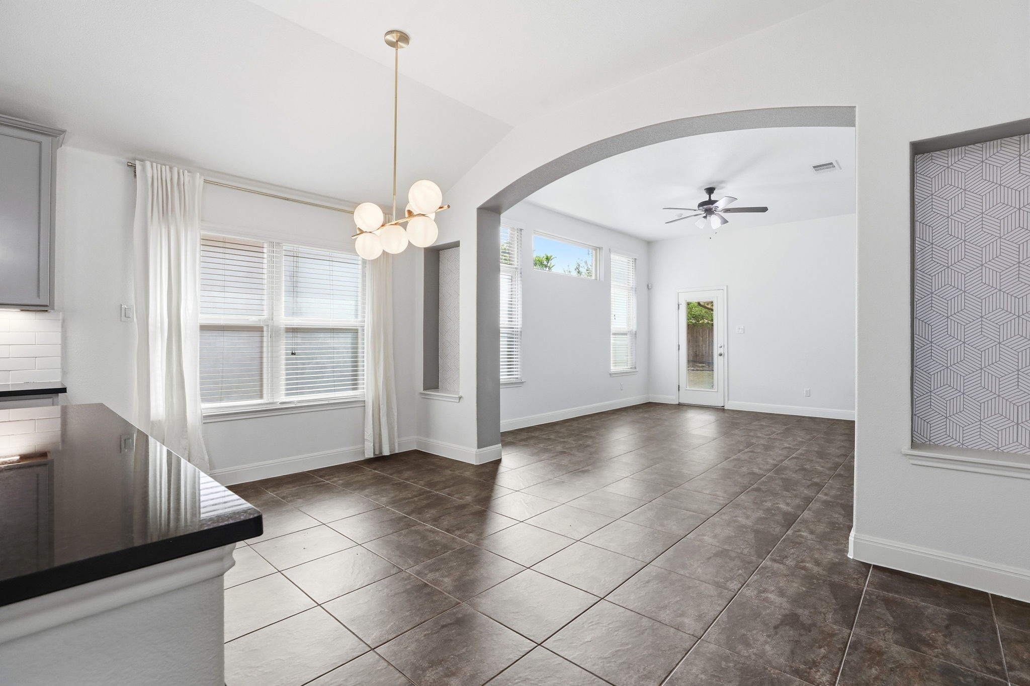 152 Stone View Trail Austin, TX 78737 - Photo 11 of 29 a view of a livingroom with a chandelier fan and windows