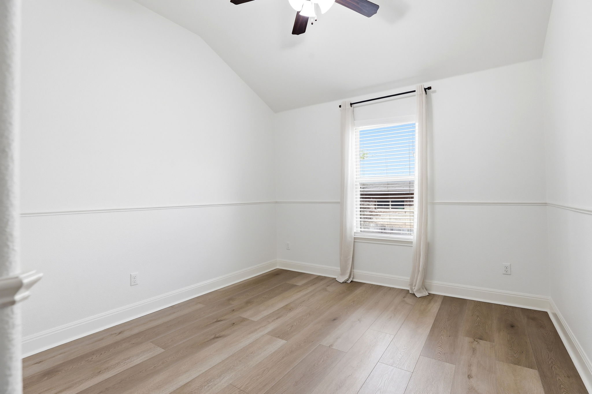 152 Stone View Trail Austin, TX 78737 - Photo 20 of 29 an empty room with wooden floor and windows