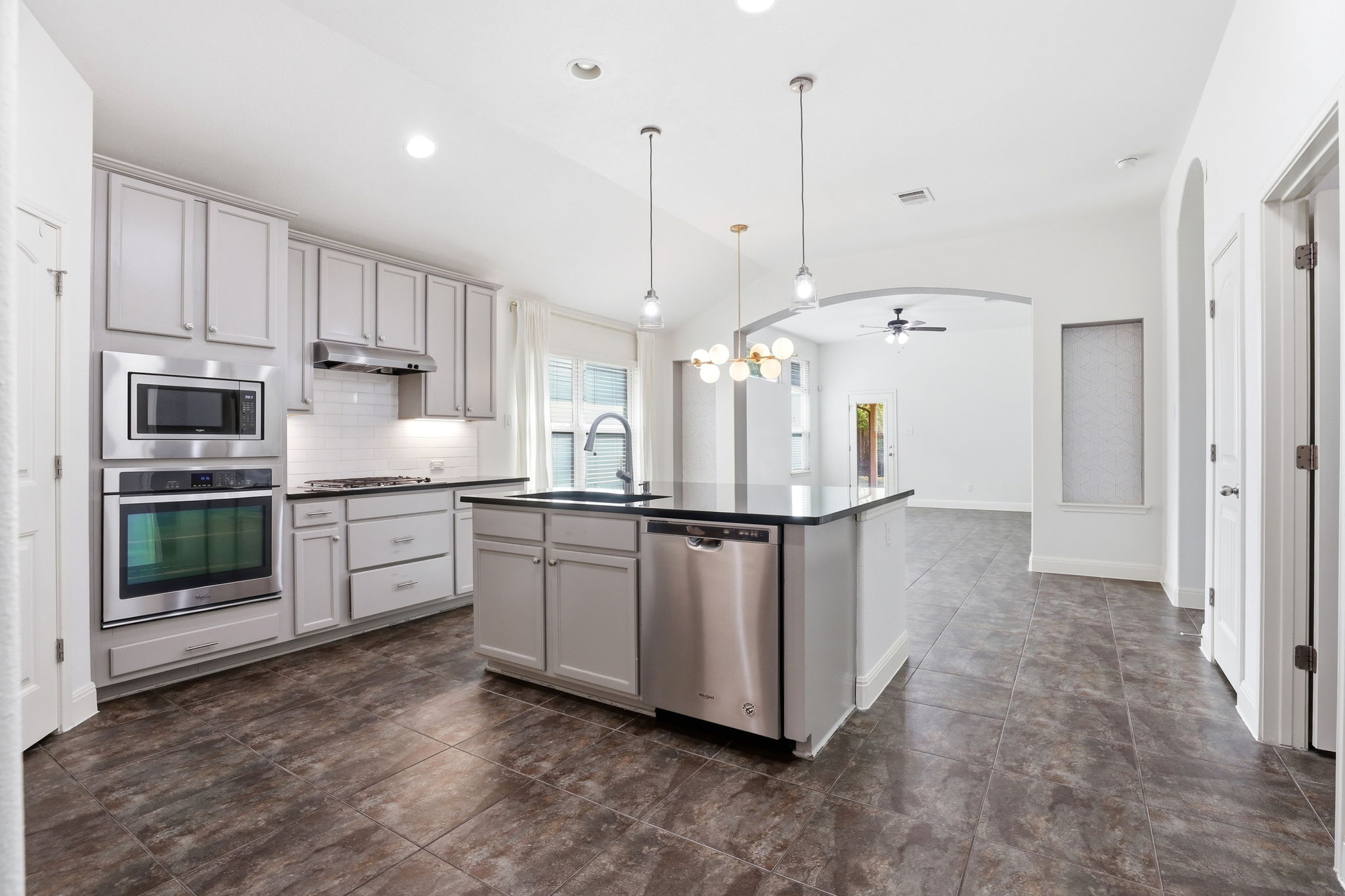 152 Stone View Trail Austin, TX 78737 - Photo 29 of 29 a kitchen with stainless steel appliances kitchen island granite countertop a refrigerator a oven a white stove with white cabinets