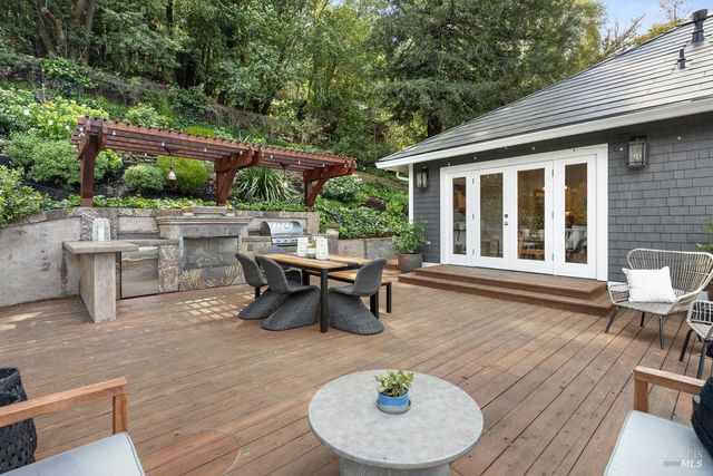 a view of a patio with table and chairs and wooden floor