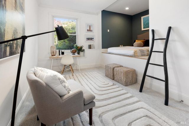 a living room with furniture and a mirror