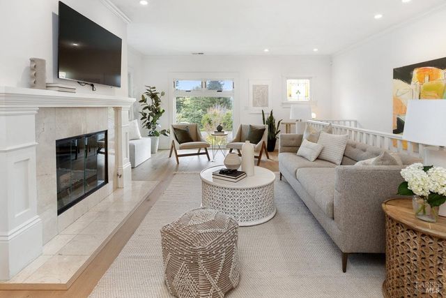 a living room with furniture fireplace and flat screen tv