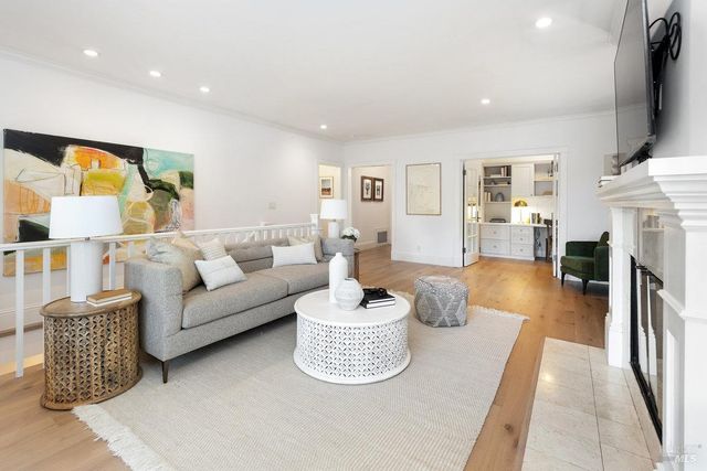 a living room with fireplace furniture and a flat screen tv