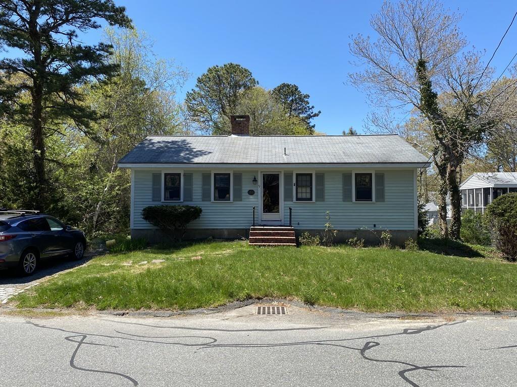 9 Uncle Percy's Road Mashpee, MA 02649 - Photo 3 of 16 a front view of a house with a garden and yard