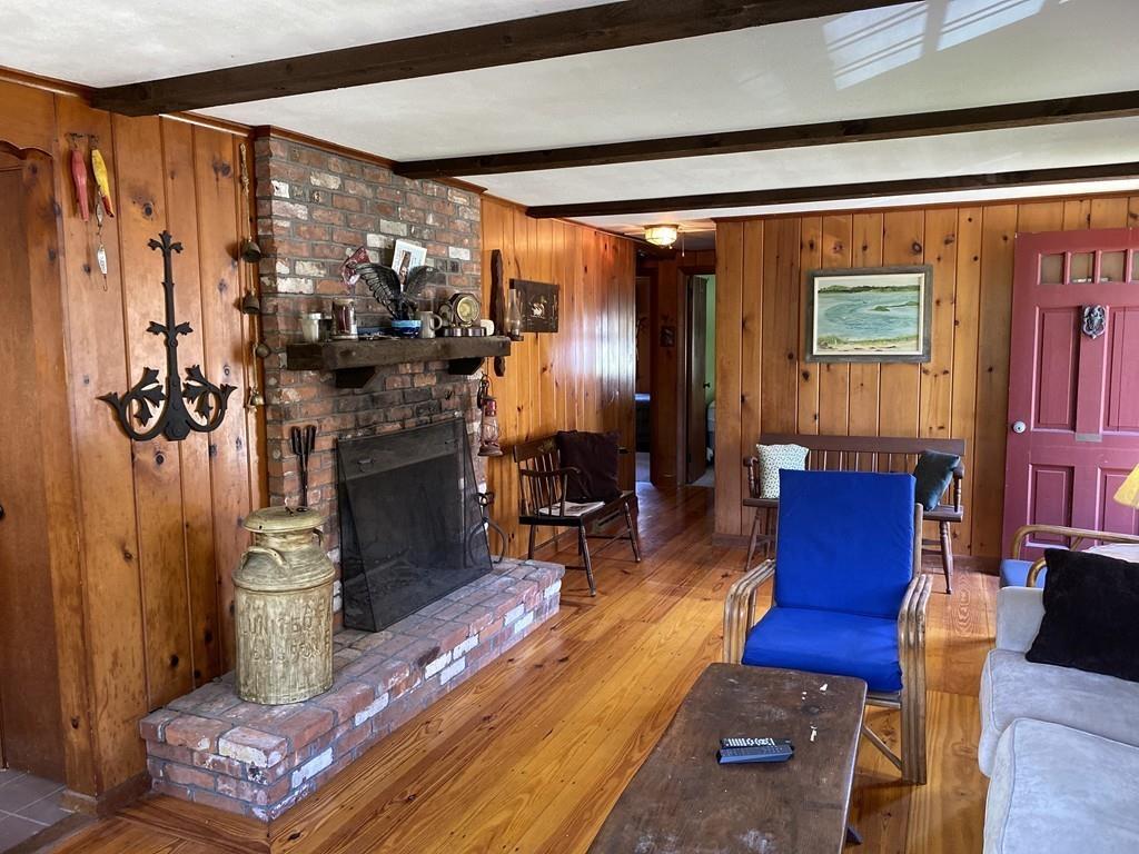 9 Uncle Percy's Road Mashpee, MA 02649 - Photo 6 of 16 a living room with furniture and a fireplace