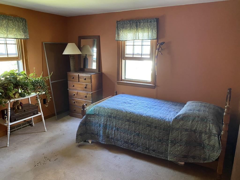 9 Uncle Percy's Road Mashpee, MA 02649 - Photo 8 of 16 a bedroom with a bed and a chair