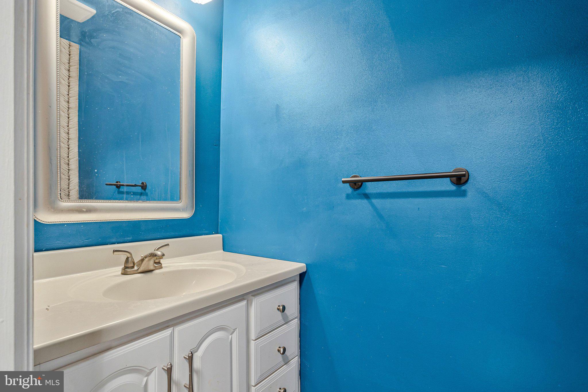 1675 Ridgely Court, Unit 182 Crofton, MD 21114 - Photo 17 of 47 a bathroom with a sink and a mirror