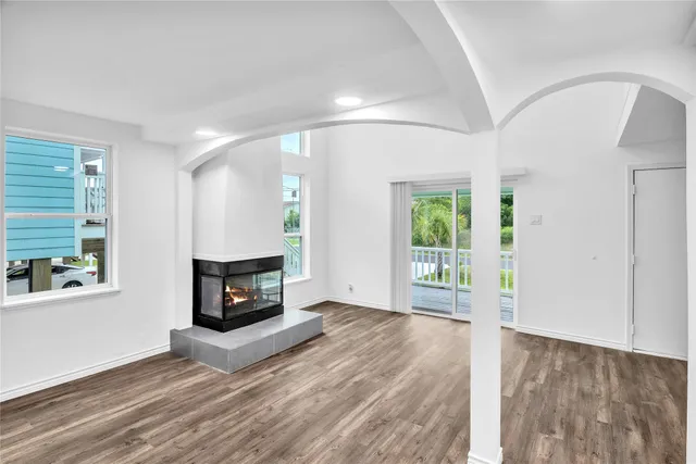 a view of an empty room with window and fire place