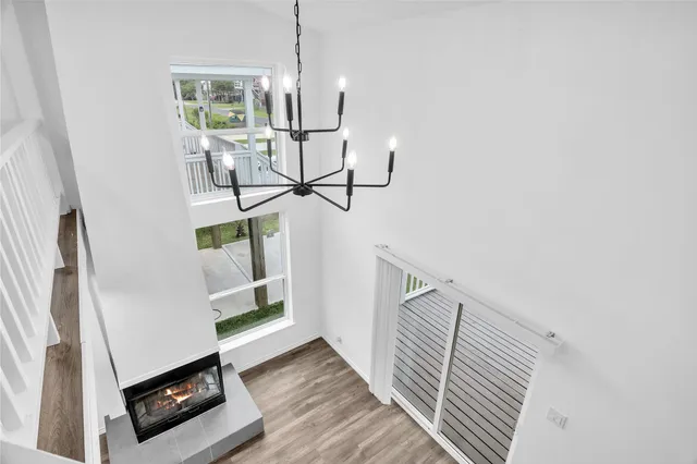 a view of a bedroom with wooden floor and staircase