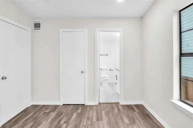 a view of an empty room and wooden floor