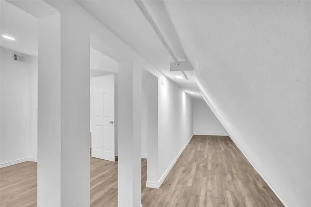 a bathroom with a granite countertop toilet a sink and mirror