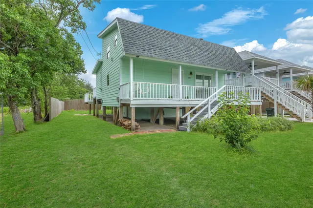 an aerial view of a house with a garden and lake view