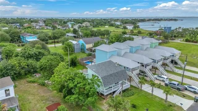 an aerial view of a houses with a lake view