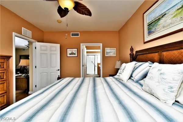 a bedroom with a large bed and a chandelier