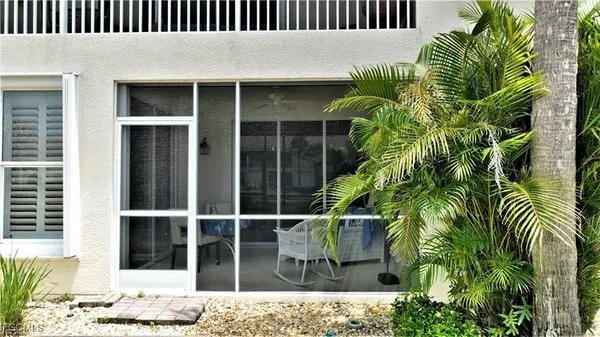 a view of front door and potted plants
