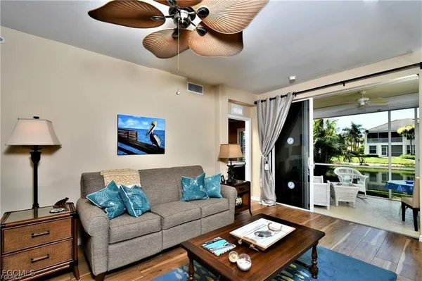 a living room with furniture and a floor to ceiling window