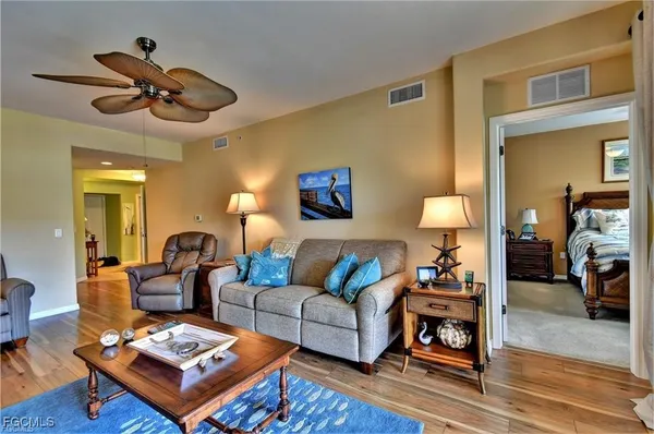 a living room with furniture a rug and a chandelier