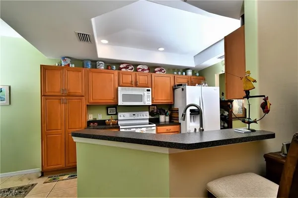 a kitchen with stainless steel appliances a sink and a refrigerator