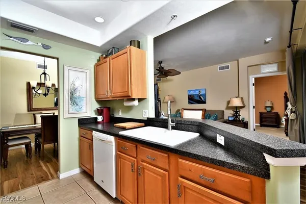 a kitchen with granite countertop a sink and cabinets