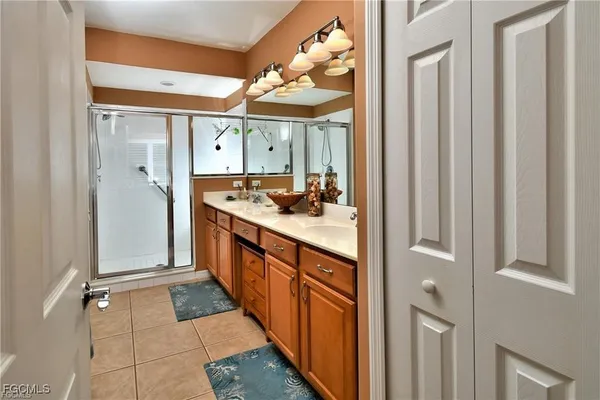 a bathroom with a double vanity sink and mirror