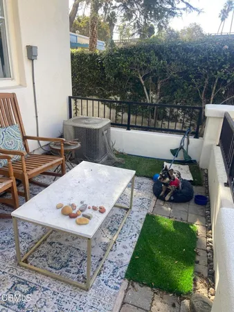 a view of a backyard with sitting area