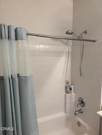 a bathroom with a shower and a tub